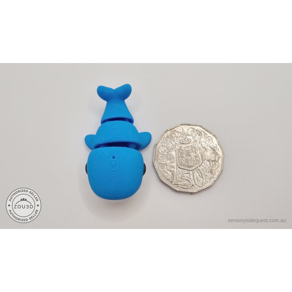 Baby Blue Whale articulated fidget toy next to Australian 50c coin for size reference — overhead flat-lay, own photo by Sensory Sidequest