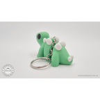 Baby Stegosaurus keychain — rear side view showing plate detail and keyring
