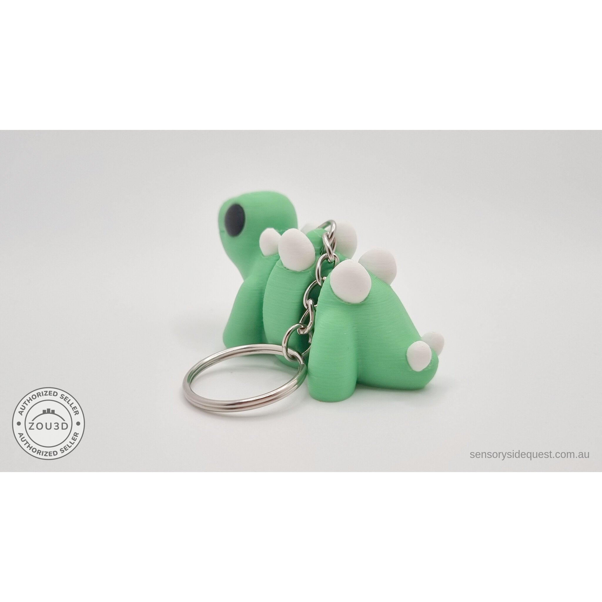 Baby Stegosaurus keychain — rear side view showing plate detail and keyring