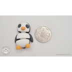 Penguin articulated fidget toy size reference next to Australian 50 cent coin, showing compact palm-sized scale — 3D printed articulated fidget toy by Sensory Sidequest