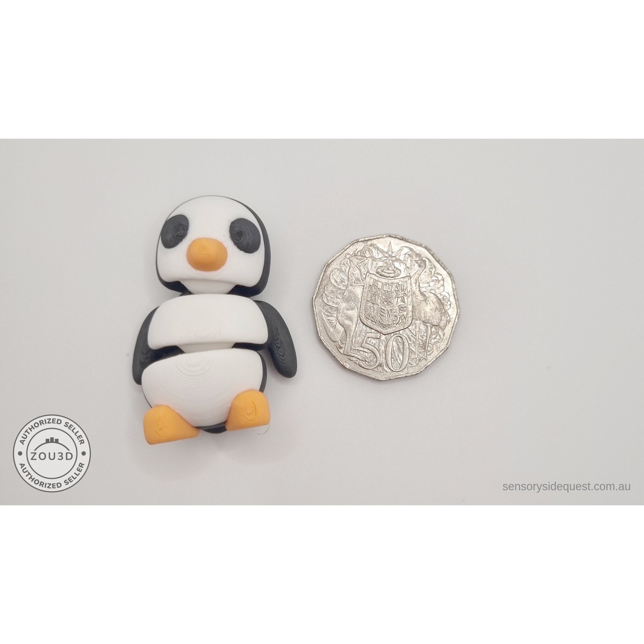 Penguin articulated fidget toy size reference next to Australian 50 cent coin, showing compact palm-sized scale — 3D printed articulated fidget toy by Sensory Sidequest
