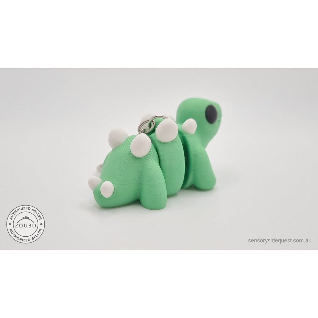 Baby Stegosaurus keychain — rear three-quarter angle with chain and ring visible