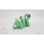 Baby Stegosaurus keychain — rear three-quarter angle with chain and ring visible