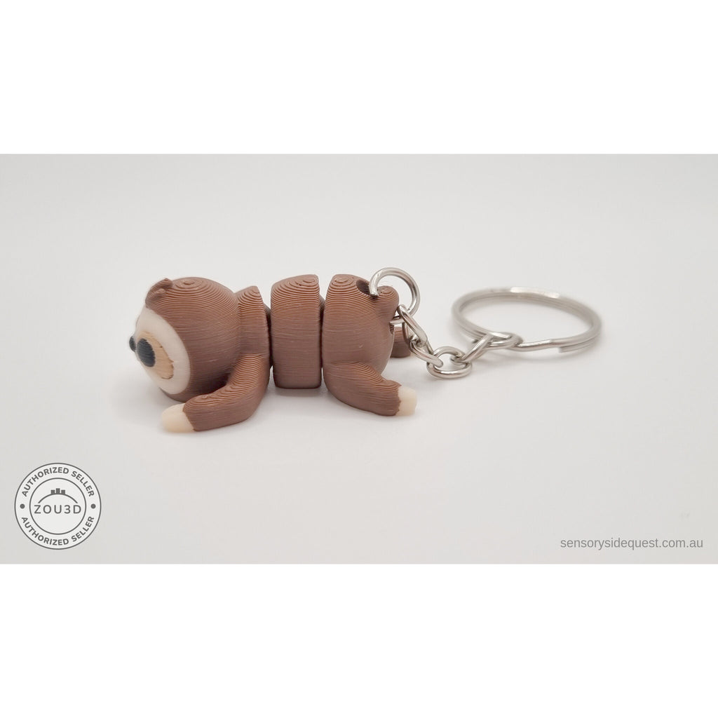 Baby Sloth keychain articulated toy — side view showing body and key ring attachment, own photo by Sensory Sidequest