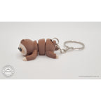 Baby Sloth keychain articulated toy — side view showing body and key ring attachment, own photo by Sensory Sidequest