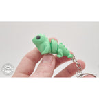 Green Baby Iguana 3D printed articulated keychain held in hand — showing compact size by Sensory Sidequest