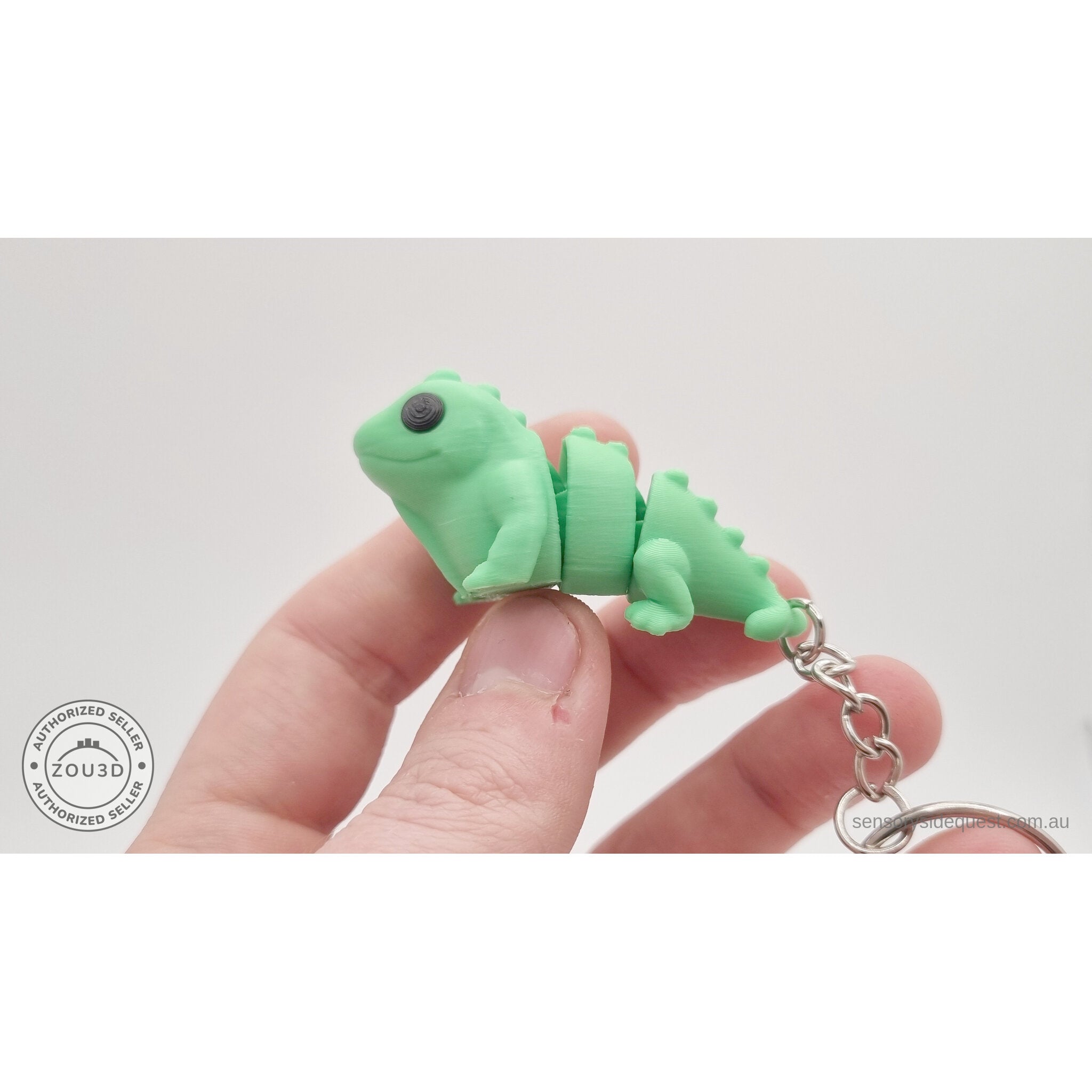 Green Baby Iguana 3D printed articulated keychain held in hand — showing compact size by Sensory Sidequest
