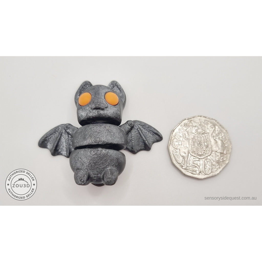 Tiny Bat with orange eyes next to Australian 50 cent coin — scale reference shot