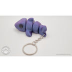 027-TNYSHK Tiny Shark keychain in crushed electric purple — rear view showing tail-first orientation and keychain chain hanging below — 3D printed articulated fidget toy by Sensory Sidequest