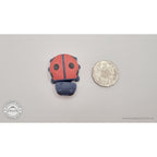 Baby Ladybug beside Australian 50 cent coin — scale reference showing compact pocket size