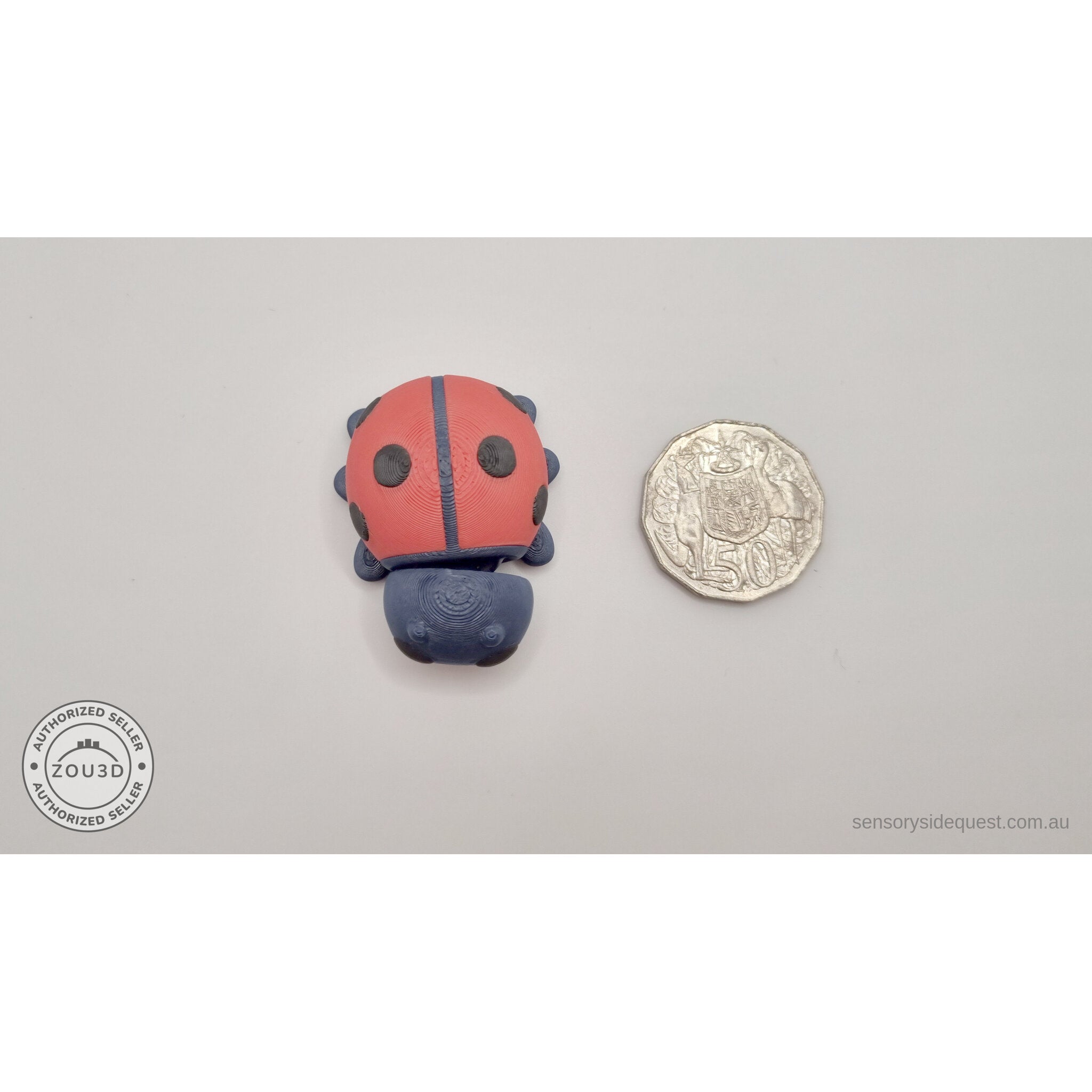 Baby Ladybug beside Australian 50 cent coin — scale reference showing compact pocket size