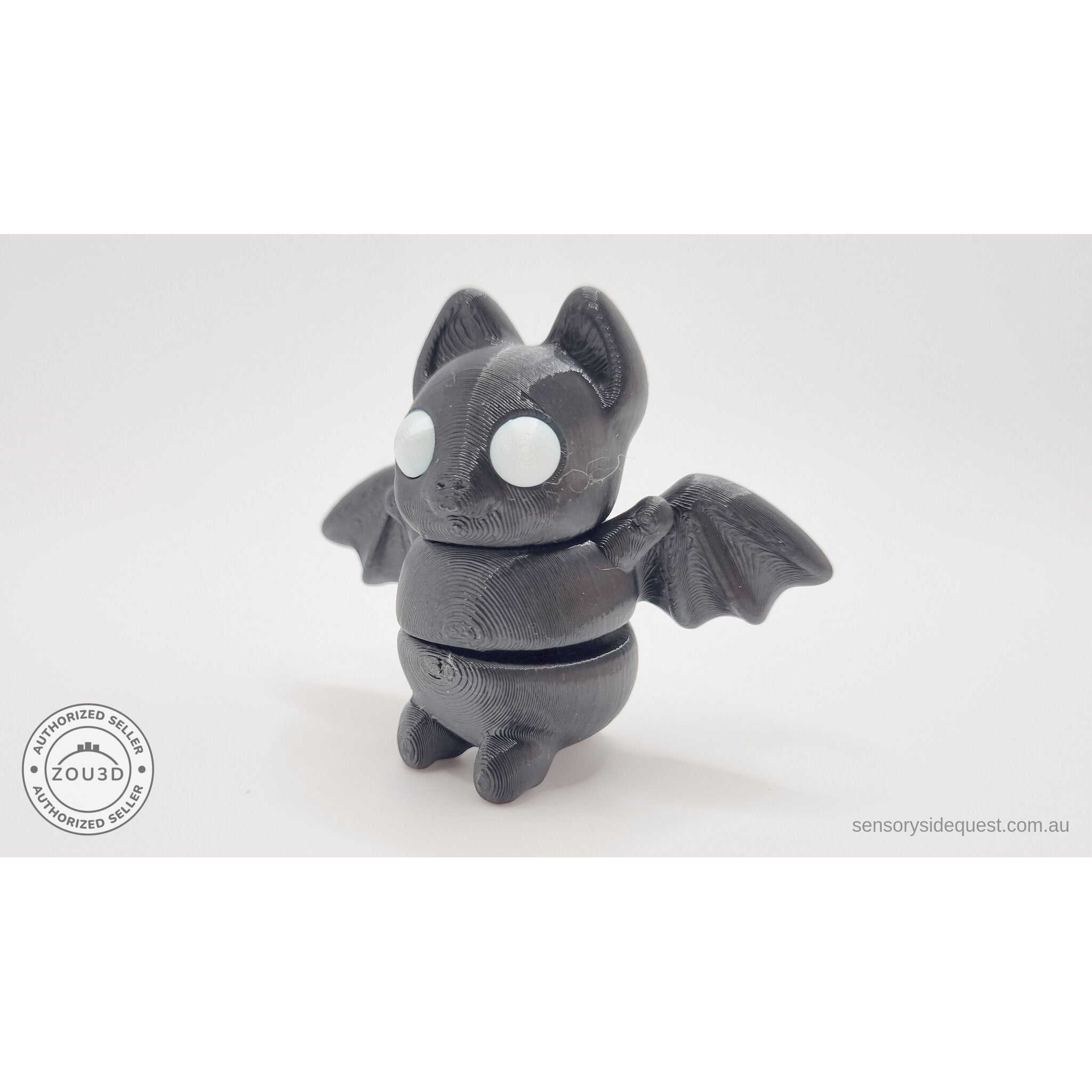 Tiny Bat articulated fidget toy — white/glow eye variant, front-facing view
