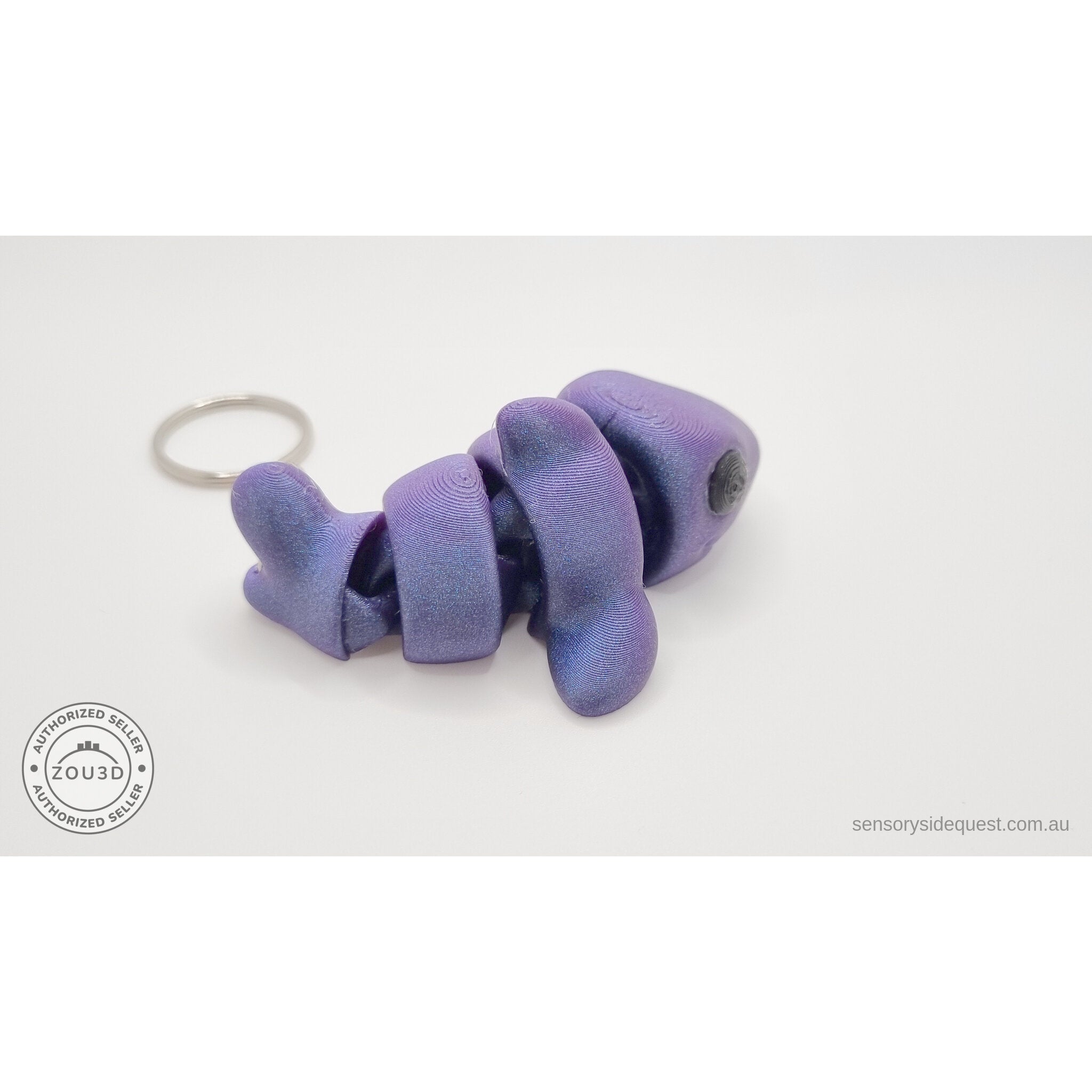 027-TNYSHK Tiny Shark keychain in crushed electric purple — side view with body coiled, iridescent shimmer finish clearly visible across all segments — 3D printed articulated fidget toy by Sensory Sidequest