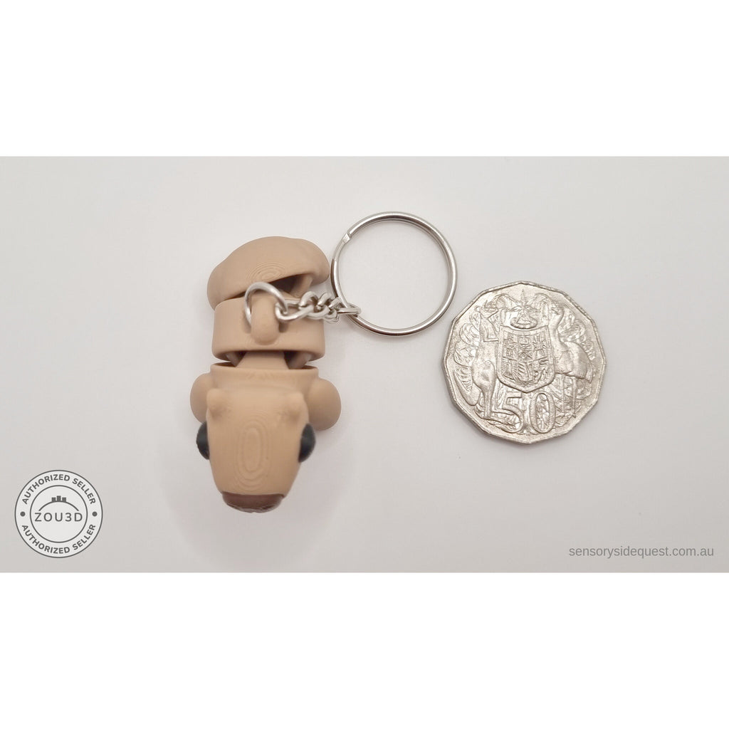 Baby Capybara smooth keychain beside Australian 50 cent coin — scale reference