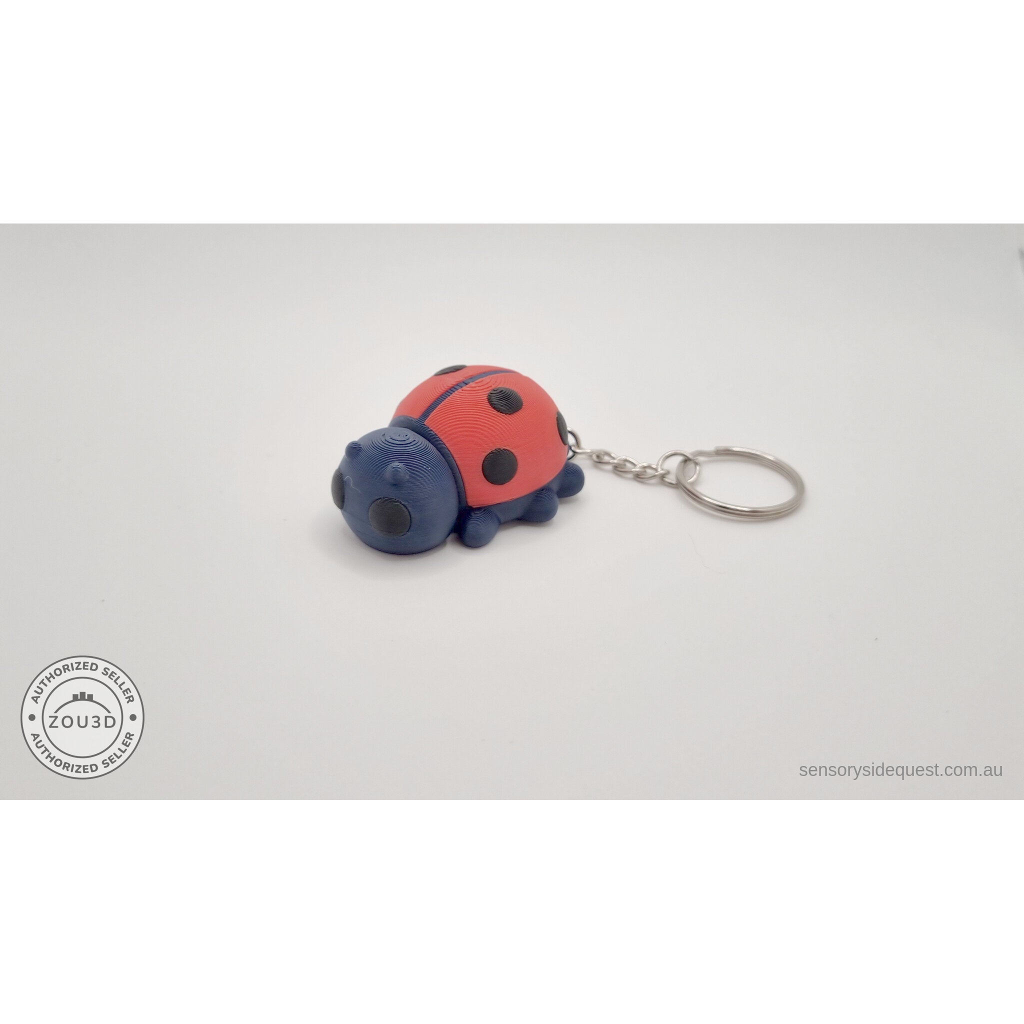 Baby Ladybug keychain variant — side view with metal ring and chain hardware