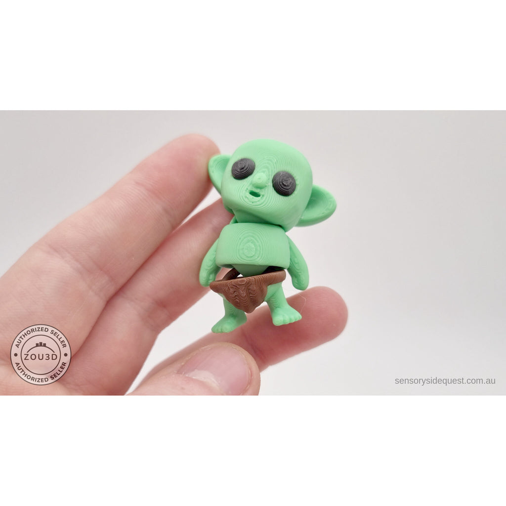 Tiny Goblin 3D printed toy held in hand — angled view showing articulated form