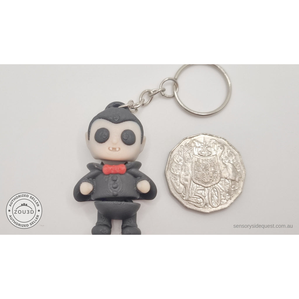 Tiny Dracula keychain variant next to Australian 50c coin for size reference — own photo by Sensory Sidequest