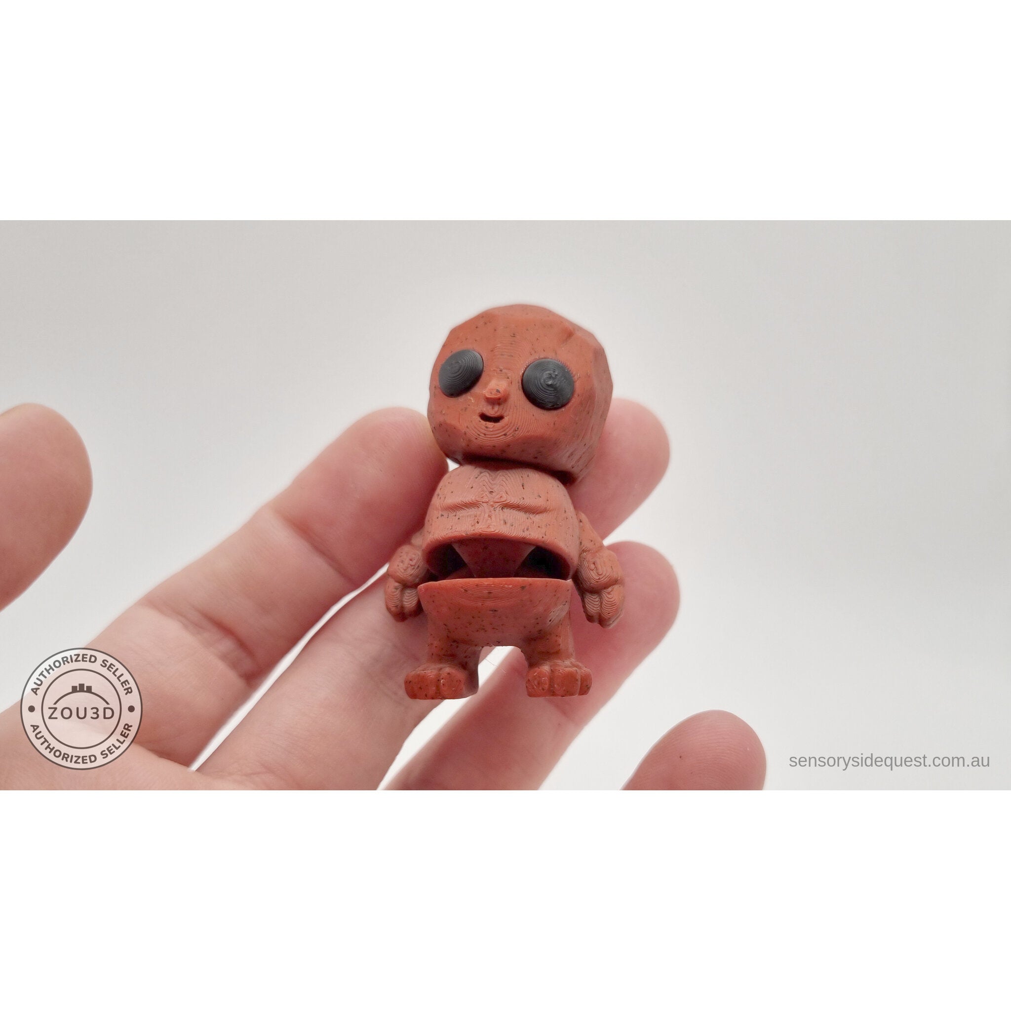 Terracotta Tiny Rock Golem held in hand showing flexible articulated body by Sensory Sidequest
