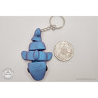 027-TNYSHK Tiny Shark keychain in gentian blue — overhead scale reference beside Australian 50 cent coin, showing metallic deep sapphire blue shimmer — 3D printed articulated fidget toy by Sensory Sidequest