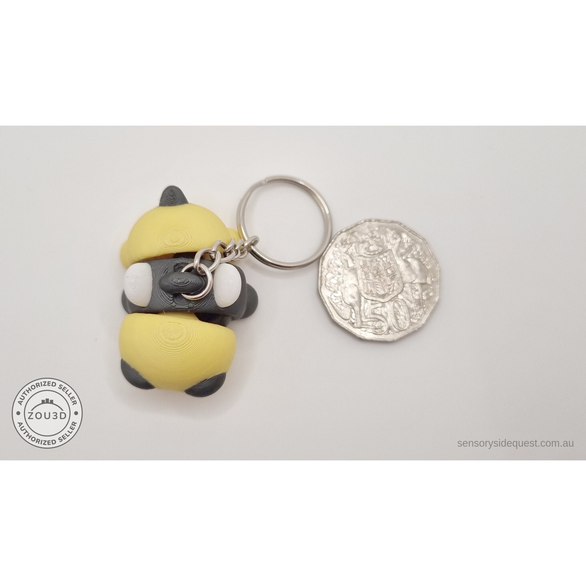 Baby Bee keychain beside Australian 50 cent coin — scale reference