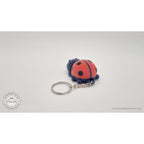 Baby Ladybug keychain — rear view showing articulated body and keyring attachment