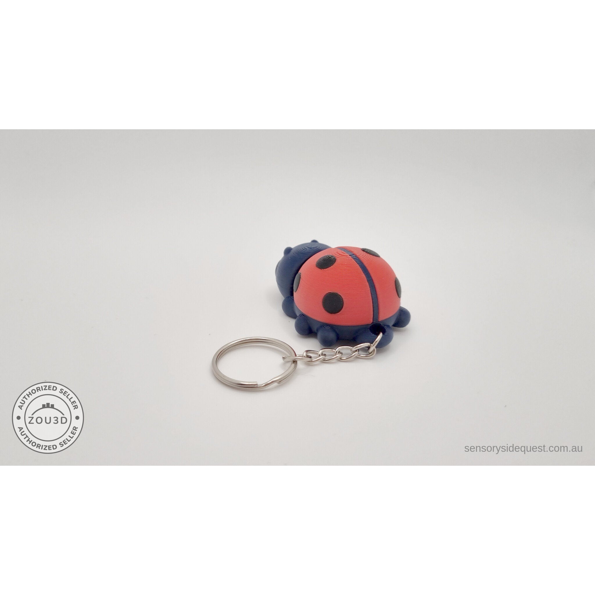 Baby Ladybug keychain — rear view showing articulated body and keyring attachment