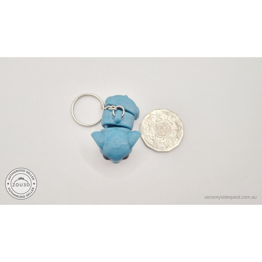 Blue Baby Elephant 3D printed keychain toy next to 50c coin for size reference