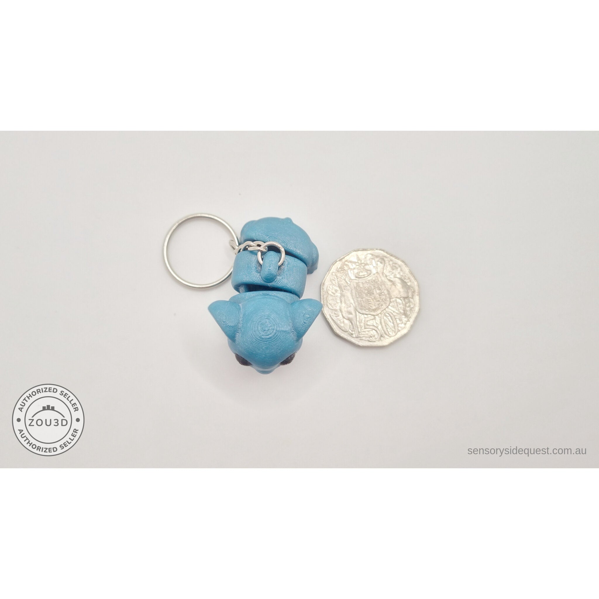 Blue Baby Elephant 3D printed keychain toy next to 50c coin for size reference