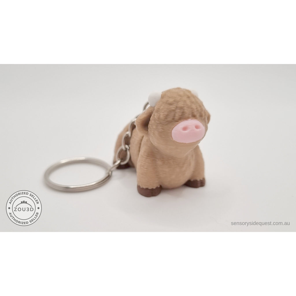 Baby Highland Cow keychain 3D printed fidget toy shown beside an Australian 50 cent coin to show size — Sensory Sidequest Australia