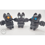 Three Tiny Bat variants side by side — orange, white, and blue eye colours — group shot