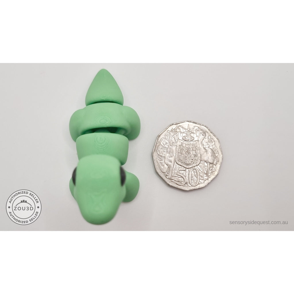 Green Baby Brontosaurus 3D printed articulated fidget toy shown with Australian 50 cent coin for scale — overhead view — Sensory Sidequest Australia