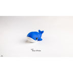 Baby Blue Whale articulated 3D printed fidget toy in bright blue by Sensory Sidequest — three-quarter front view showing full body, white belly, and raised tail flukes
