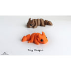 Tiny Dragon 3D printed articulated fidget toy in orange — Zou3D design by Sensory Sidequest Australia (3/4 side view, hero)
