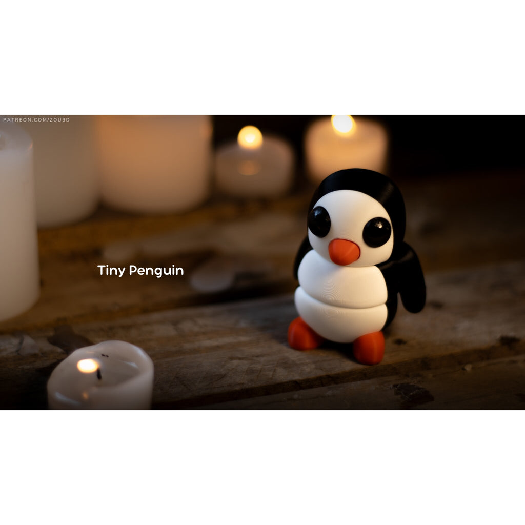 Penguin articulated fidget toy designer lifestyle render, front-facing view with candles, showing classic white and black penguin design with orange accents — 3D printed articulated fidget toy by Sensory Sidequest