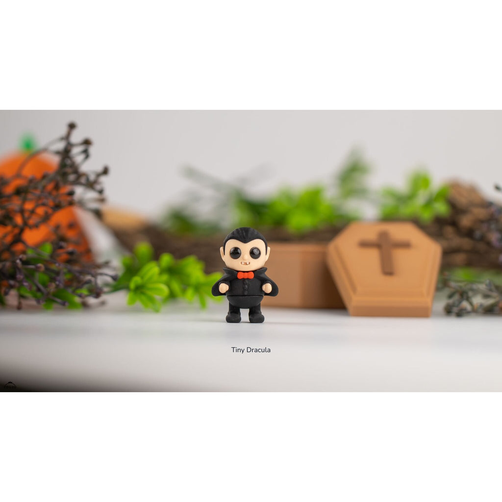 Tiny Dracula articulated 3D printed fidget toy by Sensory Sidequest — chibi vampire in black suit with red bow tie, front-facing view