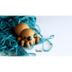 Sensory Sidequest Baby Spider 3D printed articulated fidget toy — sandy tan body with glossy black eyes, eight poseable legs, studio 3/4 front view on light background