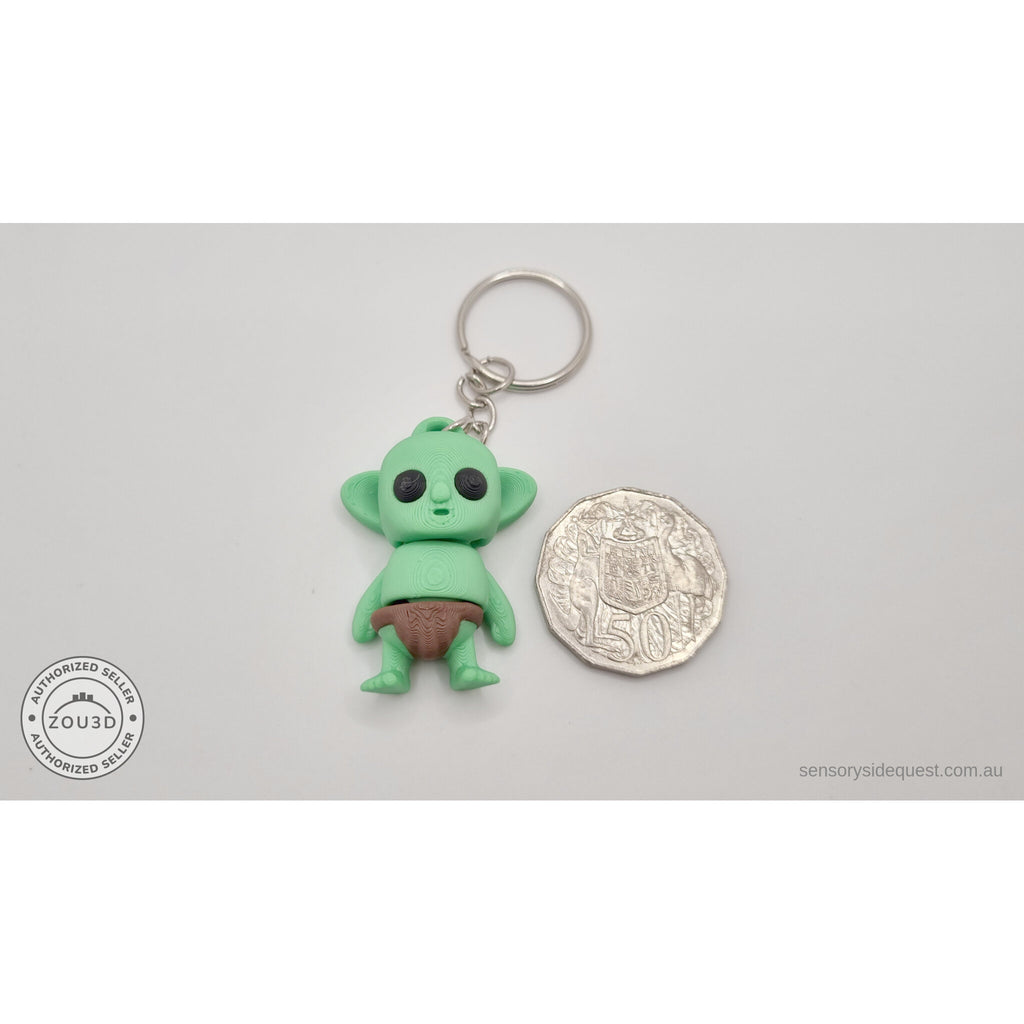 Tiny Goblin ZOU3D keychain next to Australian 50-cent coin for scale