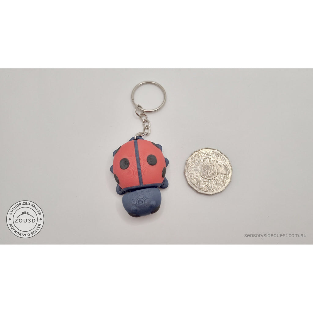 Baby Ladybug keychain beside Australian 50 cent coin — scale reference