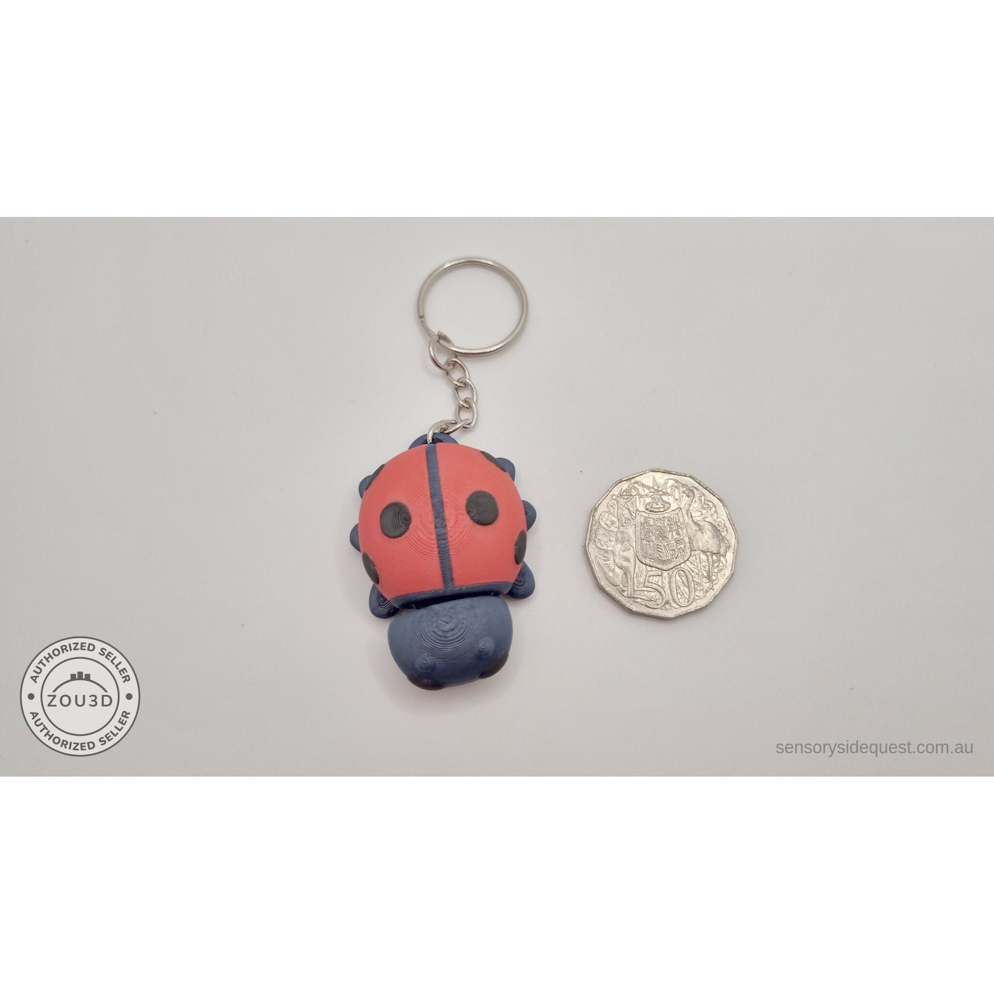 Baby Ladybug keychain beside Australian 50 cent coin — scale reference