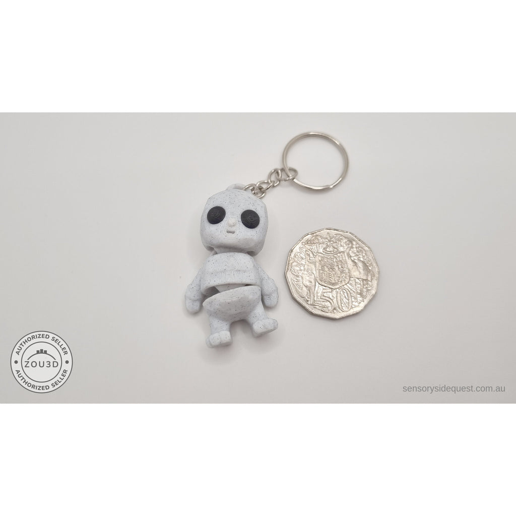 White granite Tiny Rock Golem keychain beside Australian 50-cent coin — scale reference by Sensory Sidequest