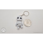 White granite Tiny Rock Golem keychain beside Australian 50-cent coin — scale reference by Sensory Sidequest