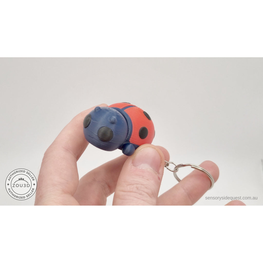 Baby Ladybug keychain held in hand — scale reference showing compact wearable size