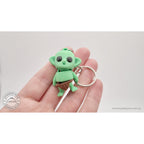 Tiny Goblin ZOU3D keychain held in hand — showing compact size and portability
