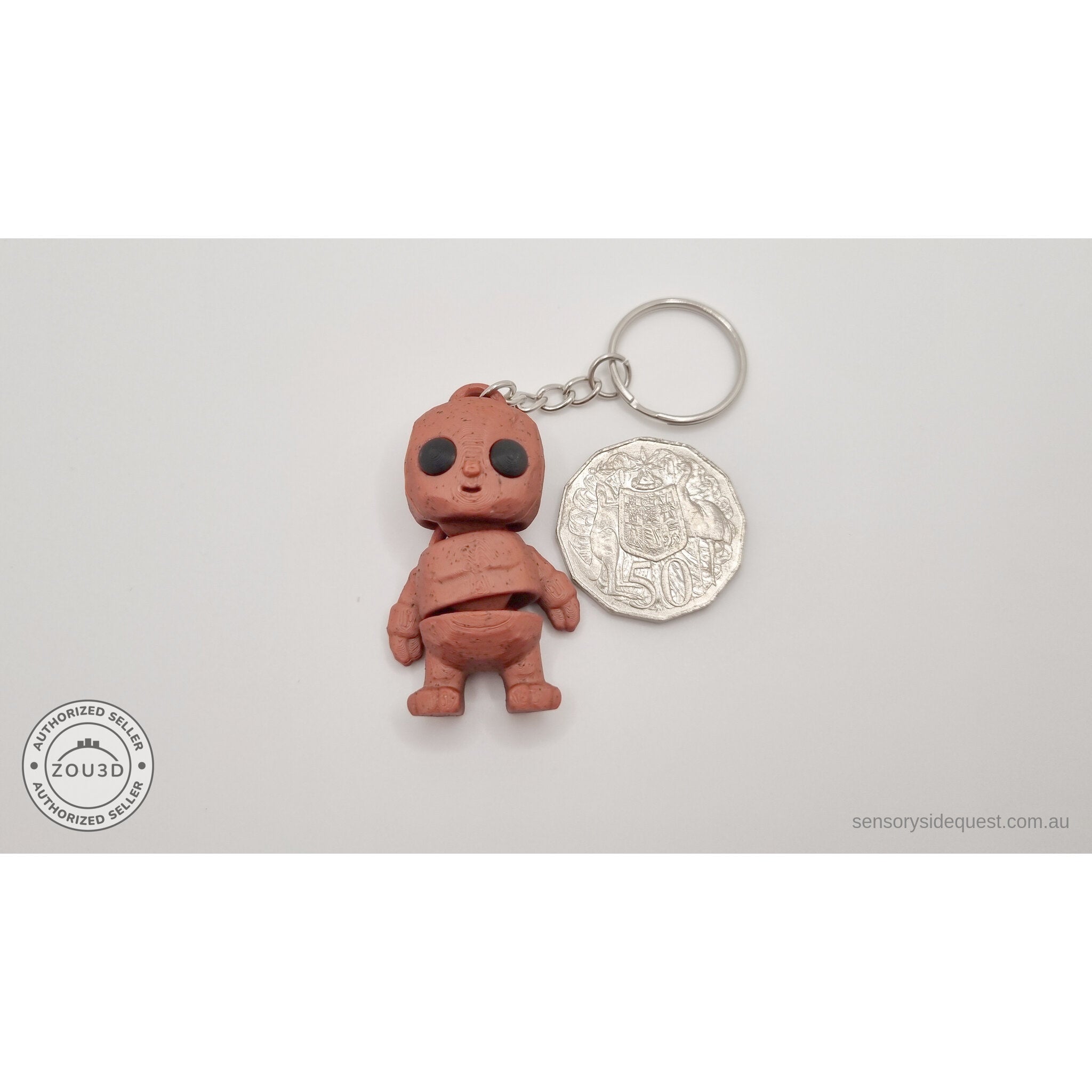 Terracotta Tiny Rock Golem keychain beside Australian 50-cent coin — scale reference by Sensory Sidequest