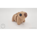 Baby Capybara fuzzy keychain — front angle showing textured body and expressive eye