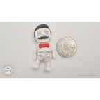 Mr.Skeleton Freddie Mercury variant beside Australian 50 cent coin — scale reference showing pompadour hair and moustache detail at palm size — 3D printed articulated fidget toy by Sensory Sidequest