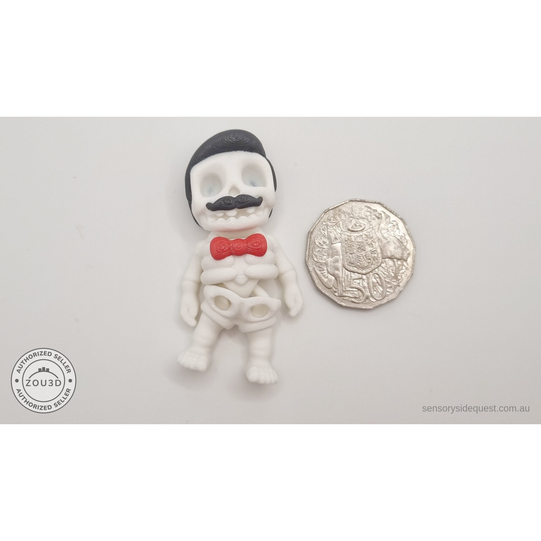Mr.Skeleton Freddie Mercury variant beside Australian 50 cent coin — scale reference showing pompadour hair and moustache detail at palm size — 3D printed articulated fidget toy by Sensory Sidequest