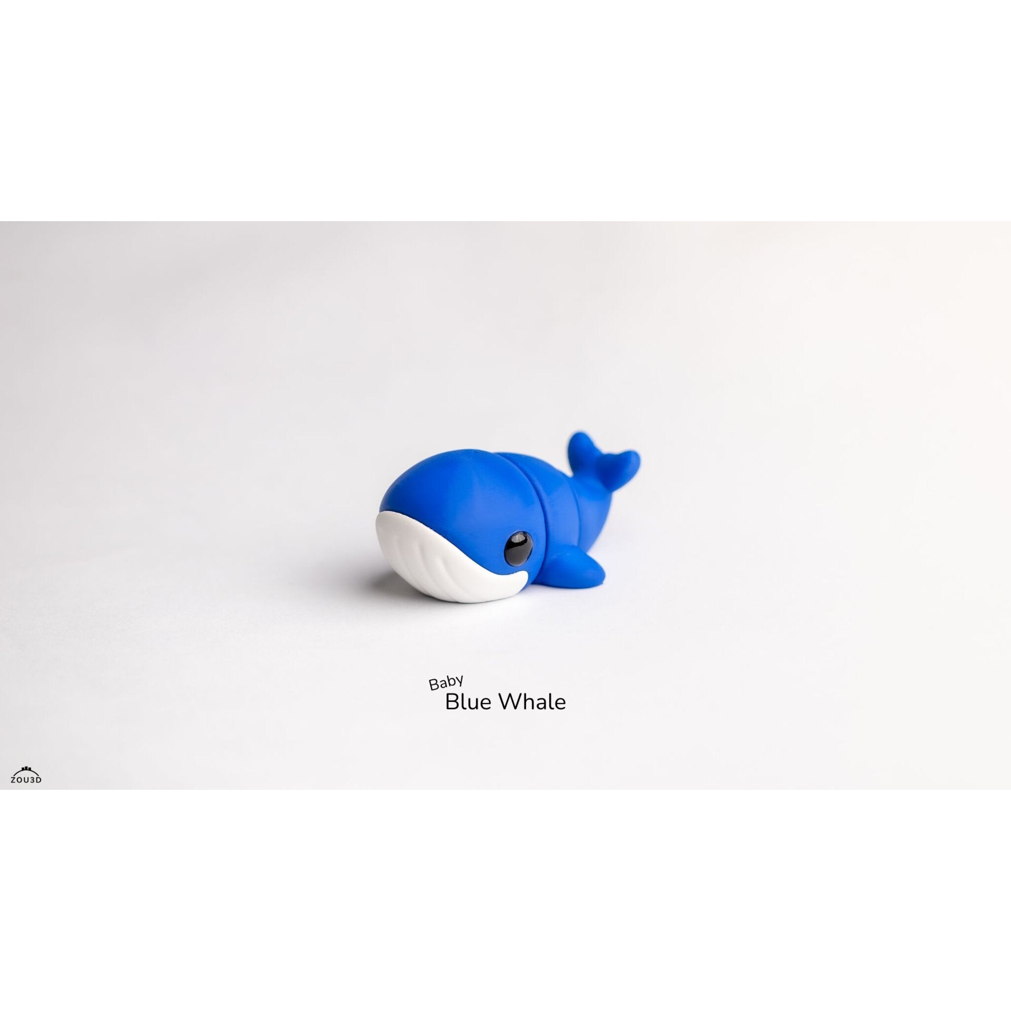 Baby Blue Whale Zou3D articulated toy — front-facing three-quarter angle showing expressive eye and blue body