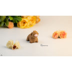 Baby Highland Cow 3D printed articulated toy — front view with floral styling showing shaggy fringe and white horns — Sensory Sidequest Australia