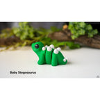 Green Baby Stegosaurus 3D printed articulated fidget toy by Sensory Sidequest
